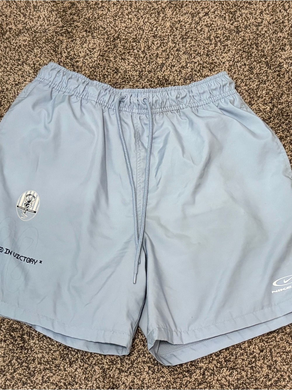 Nike Light Blue Athletic Shorts with 'Earned in Victory' Detail